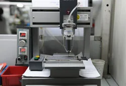 Semi-auto gluing machine at UNION TEAM ELECTRONICS